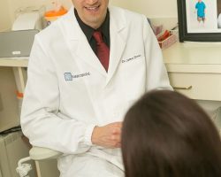 Dr. James Dores talking to a patient at Dores Dental in East Longmeadow, MA